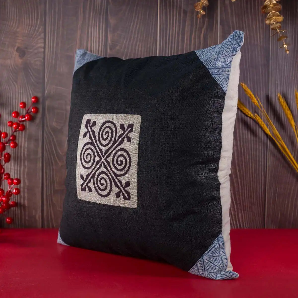 Vindigo cushion cover black embroidered spiral side angled view