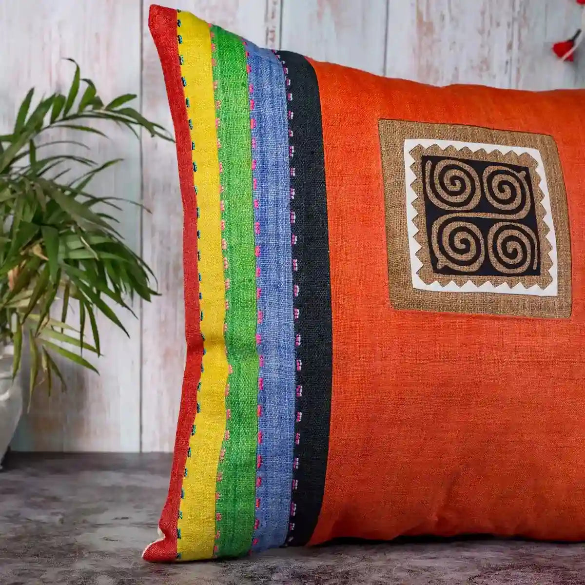 Vindigo cushion cover orange embroidered spiral side angled view