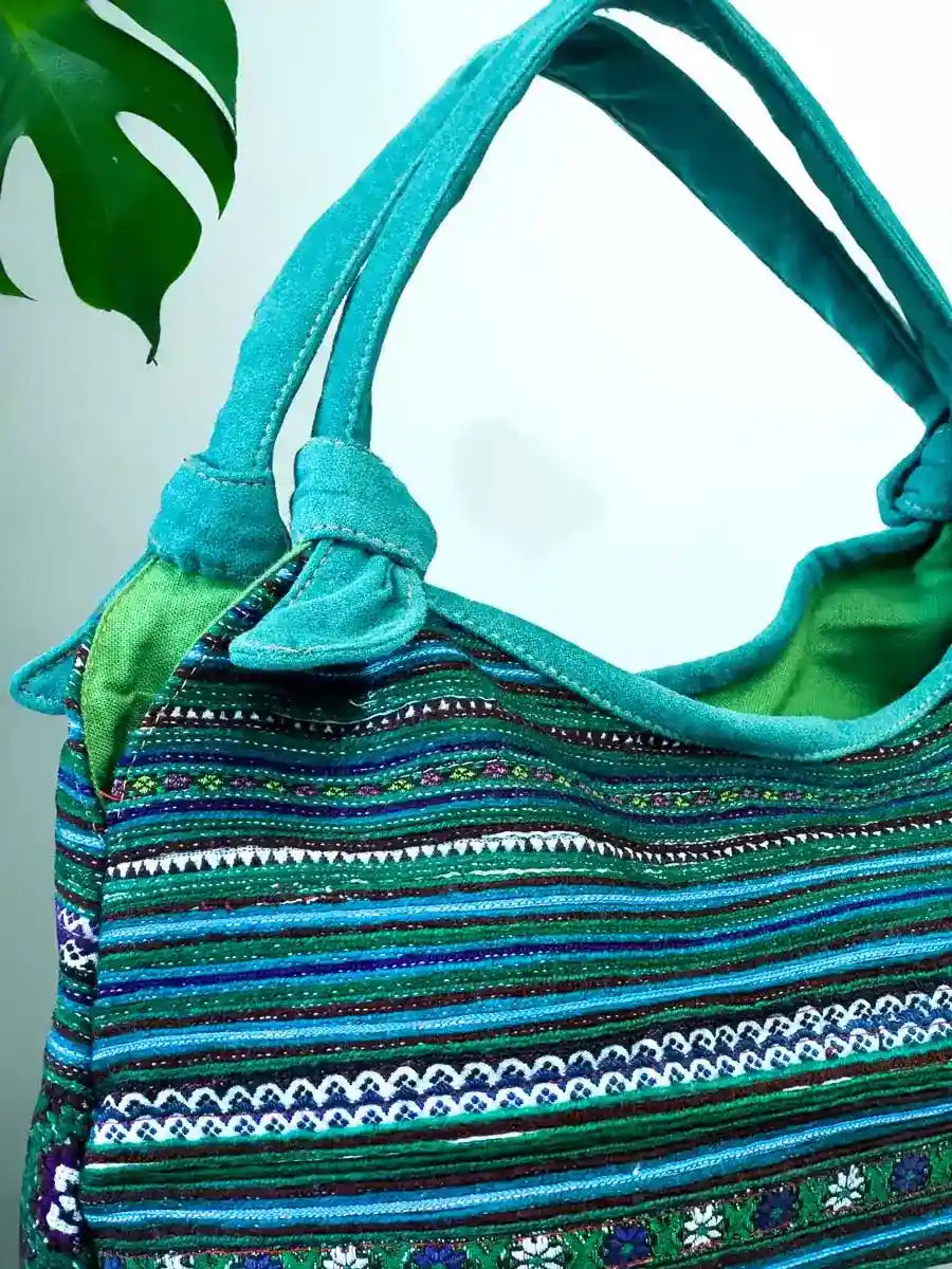 Vindigo handbag teal embroidered with green lining side close view