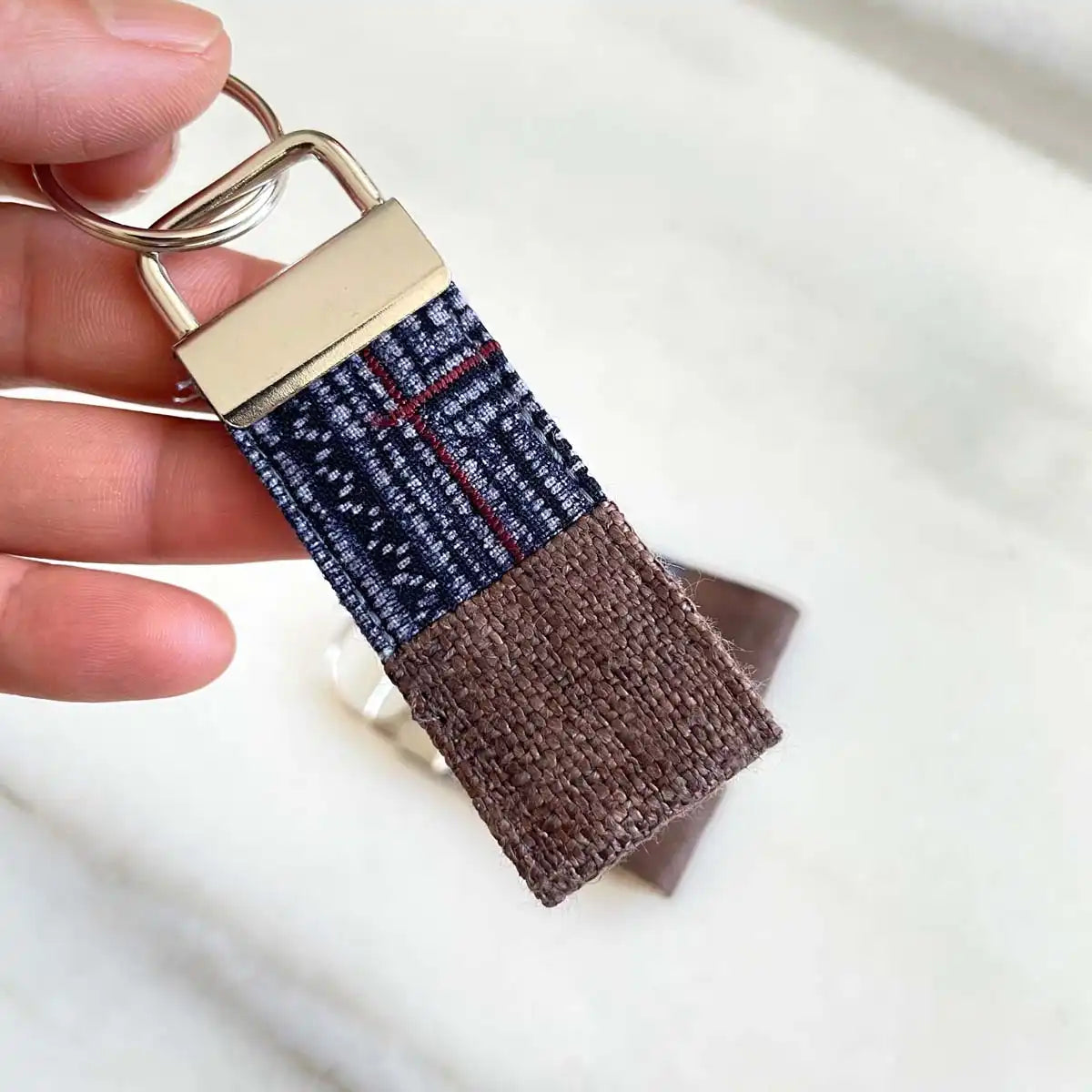 Vindigo keychain brown embroidered embroidery detail in hand