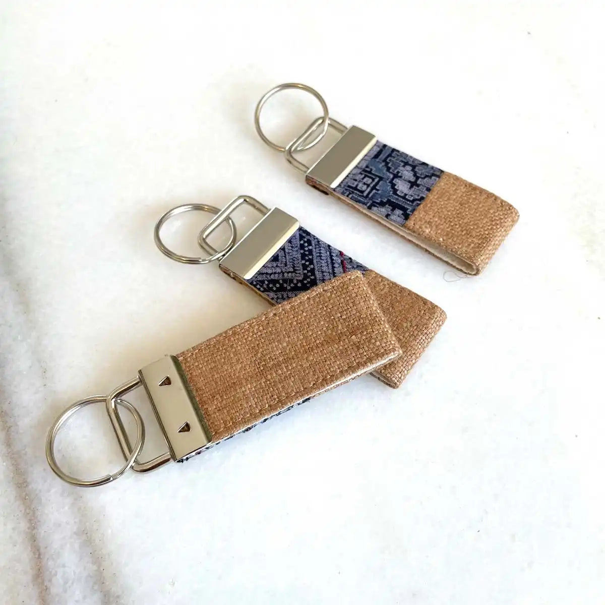 Vindigo keychain light brown embroidered angled group close view