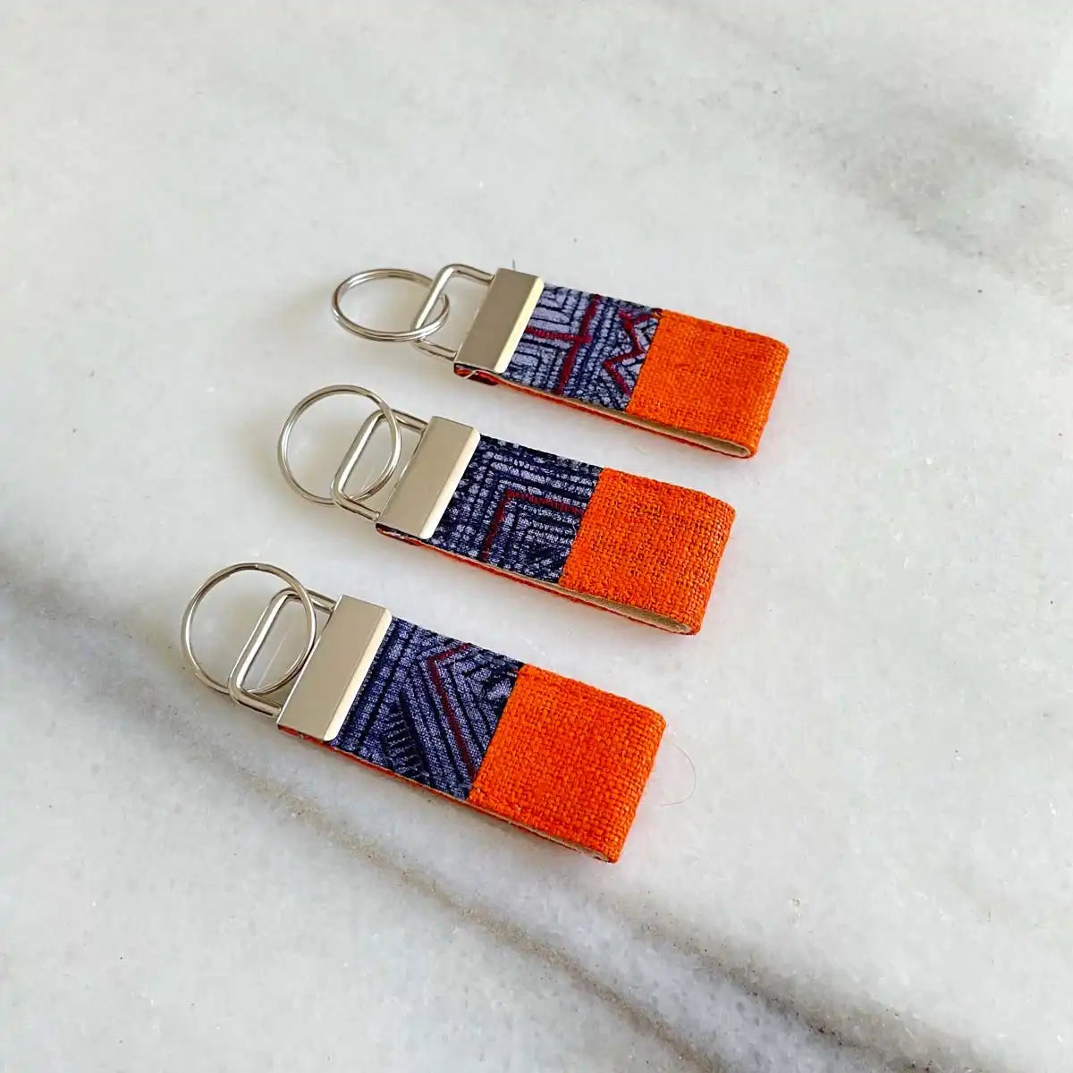 Vindigo keychain orange embroidered front view set of three