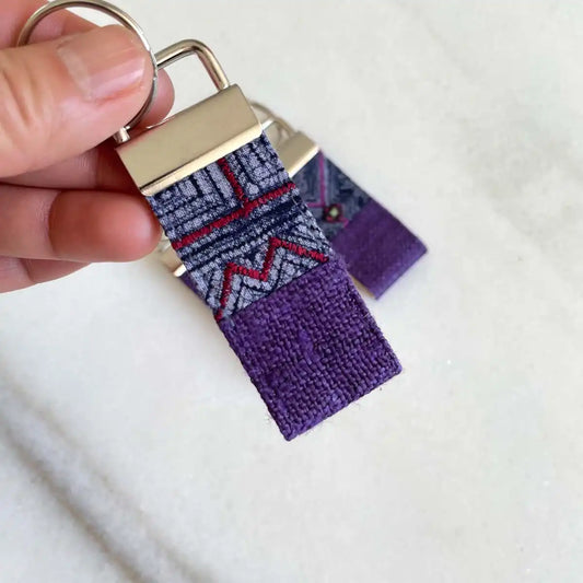Vindigo keychain purple embroidered close detail in hand