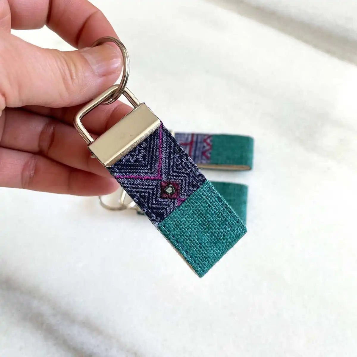 Vindigo keychain turquoise embroidered close detail in hand