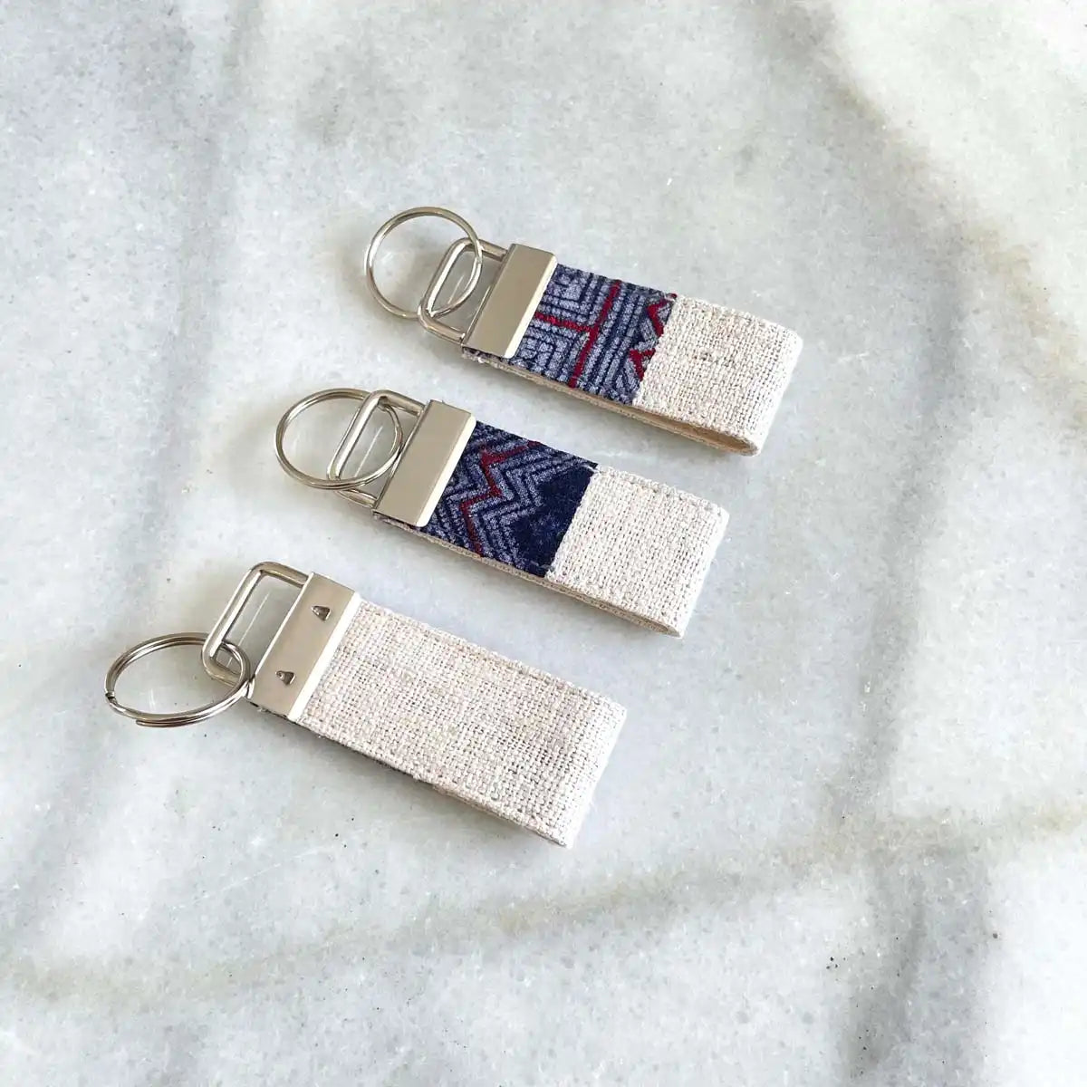 Vindigo keychain white embroidered front group angled view