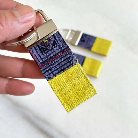 Vindigo keychain yellow embroidered close detail in hand