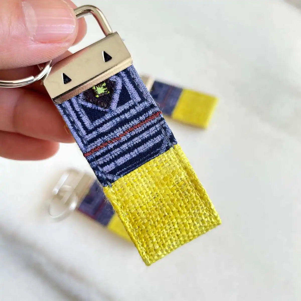 Vindigo keychain yellow embroidered angled embroidery detail