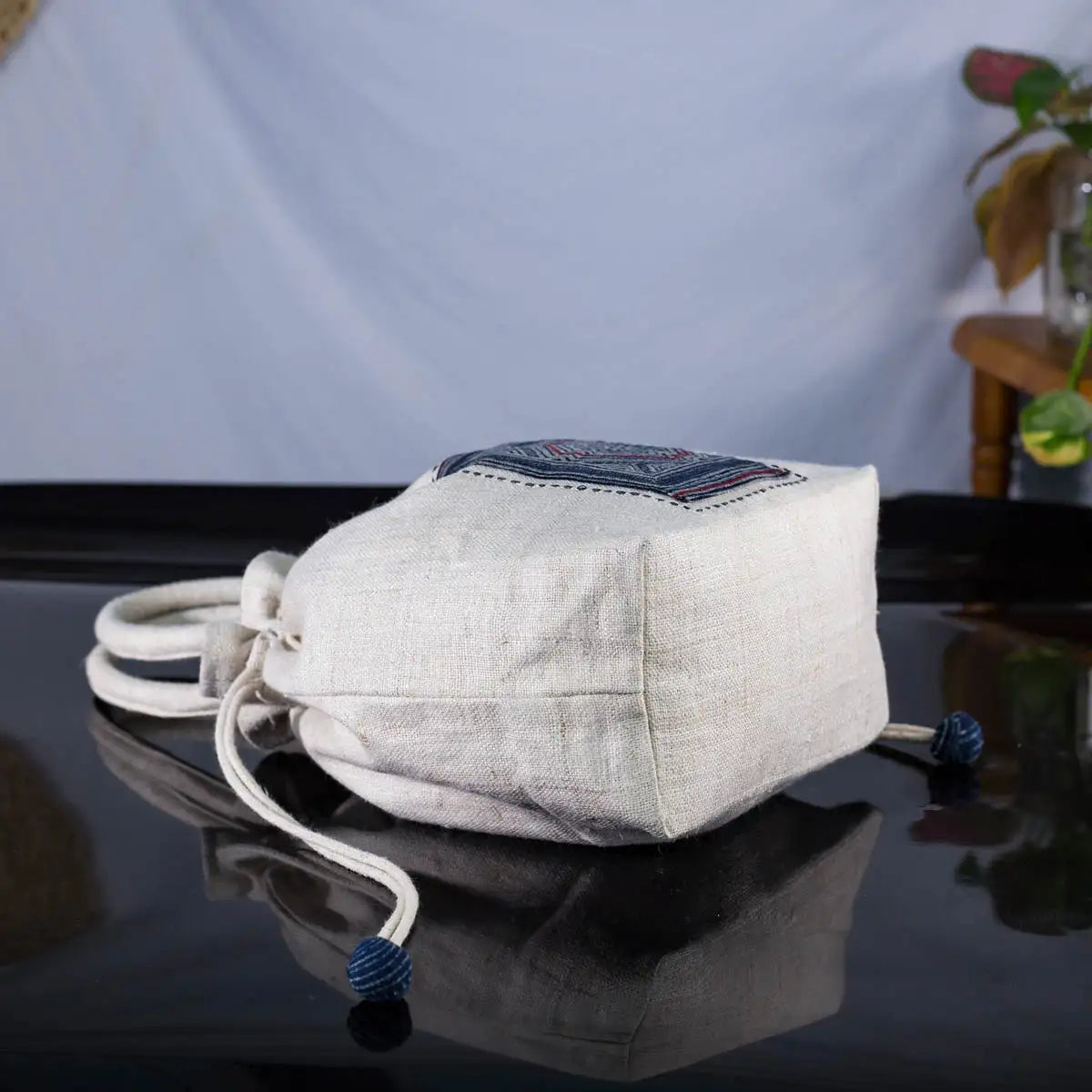 White hemp bucket bag with H’Mong batik patch – laid flat