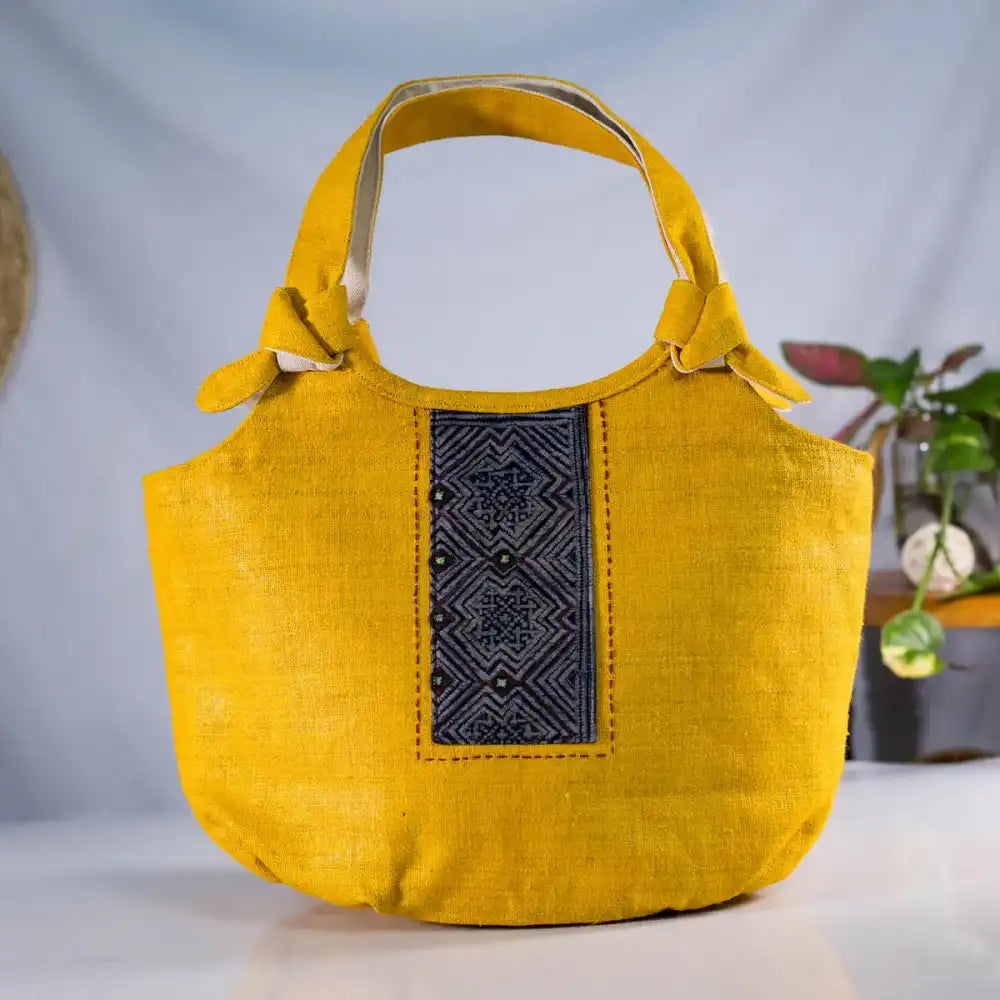 Handmade yellow hemp handbag with H’Mong patch standing upright – Vindigo eco bag