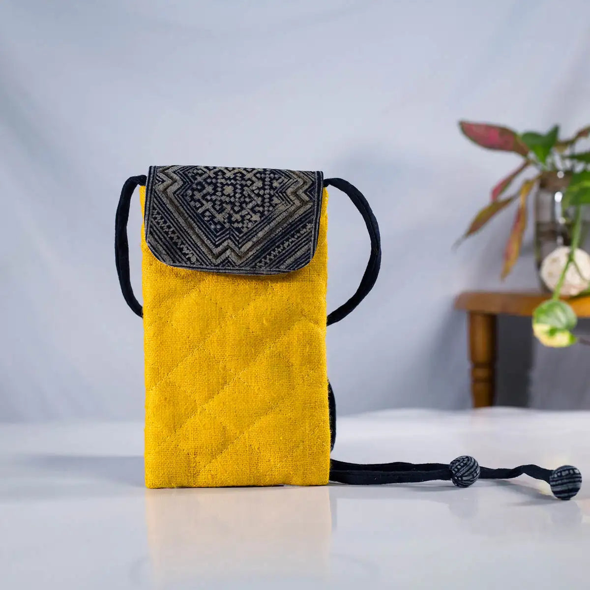 Front view of yellow hemp phone crossbody bag with vintage H’Mong patch