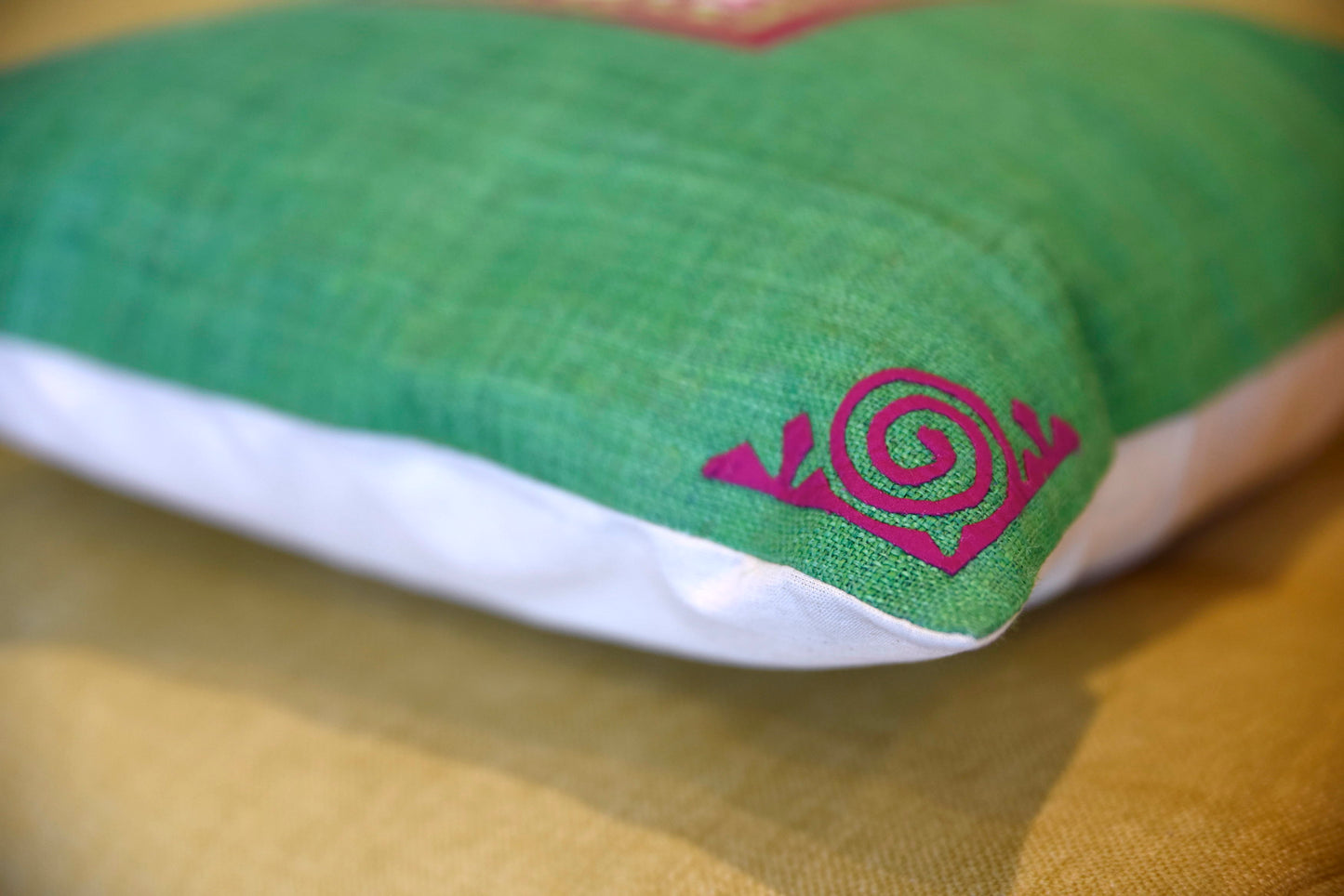 Green Cushion Cover (45x45 cm), embroidered corners, white patch on pink background