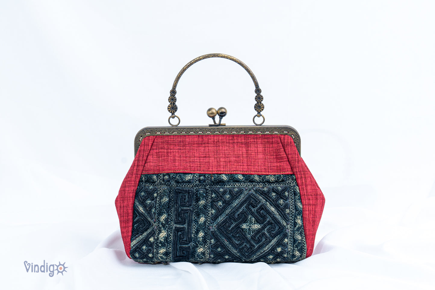 Red bag with vintage tribal embroidery and straight copper-binding