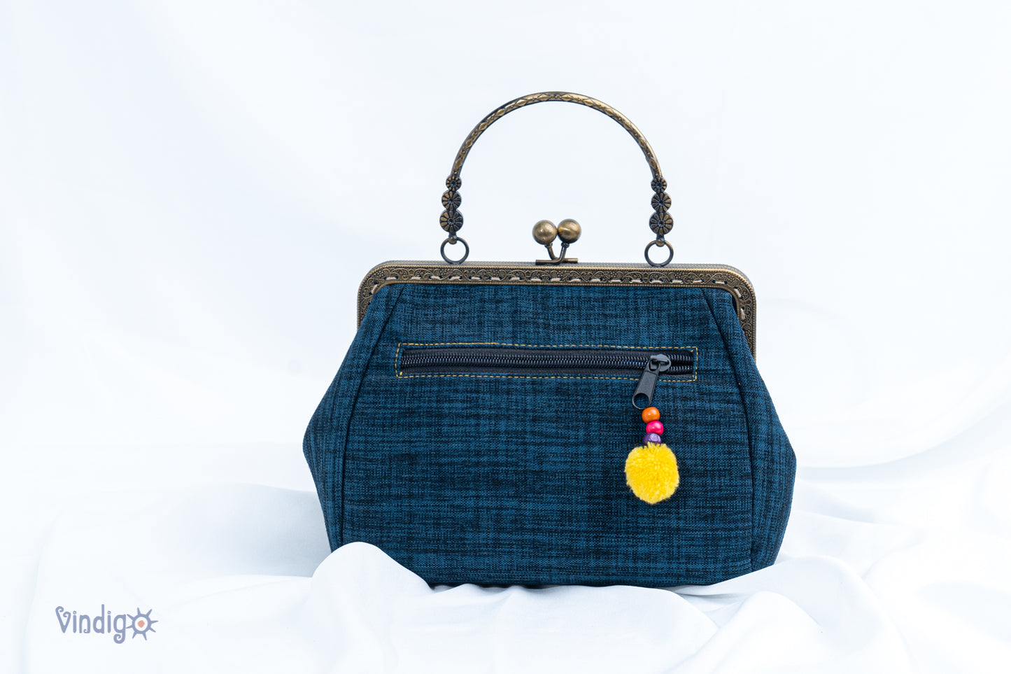 Blue bag with vintage tribal embroidery and straight copper-binding