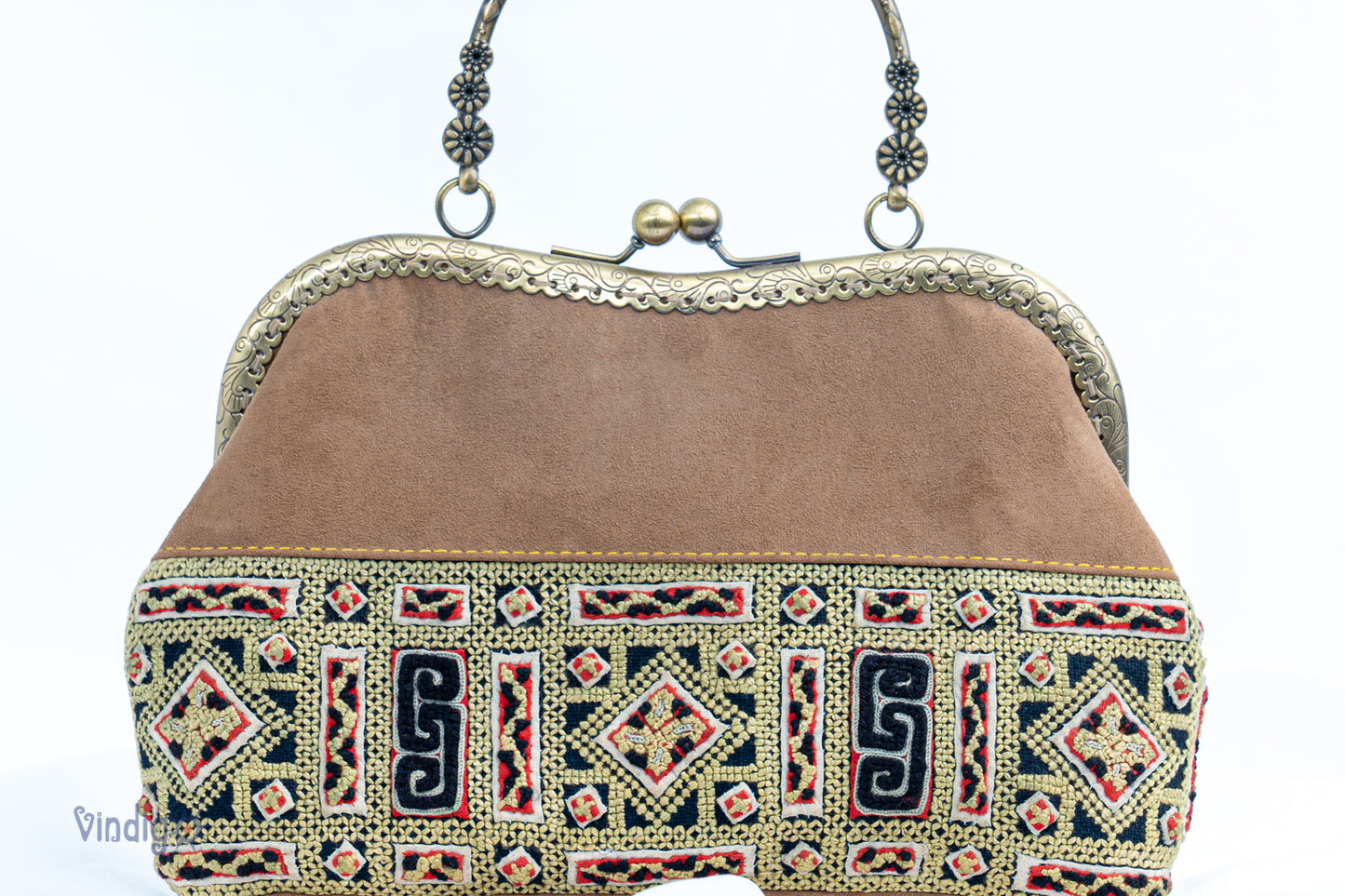 Suede leather bag with vintage tribal embroidery and copper-binding