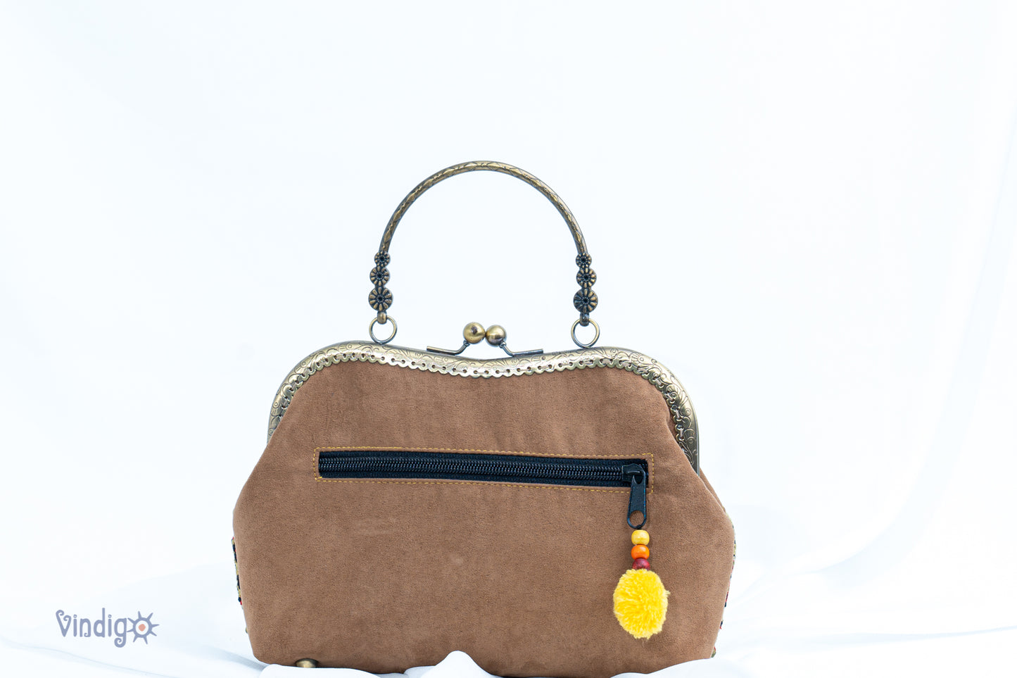 Suede leather bag with vintage tribal embroidery and copper-binding