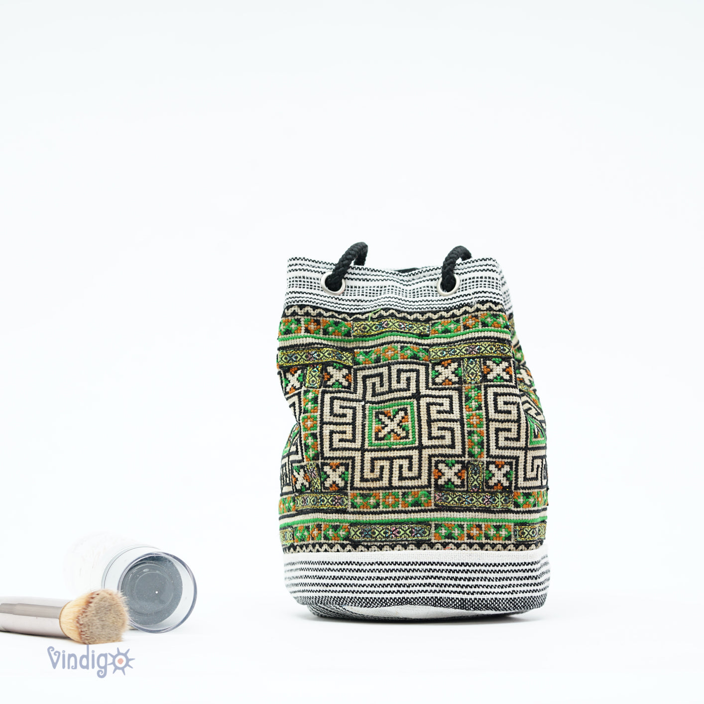 Mini hemp bag with string, tribal pattern in white on green background