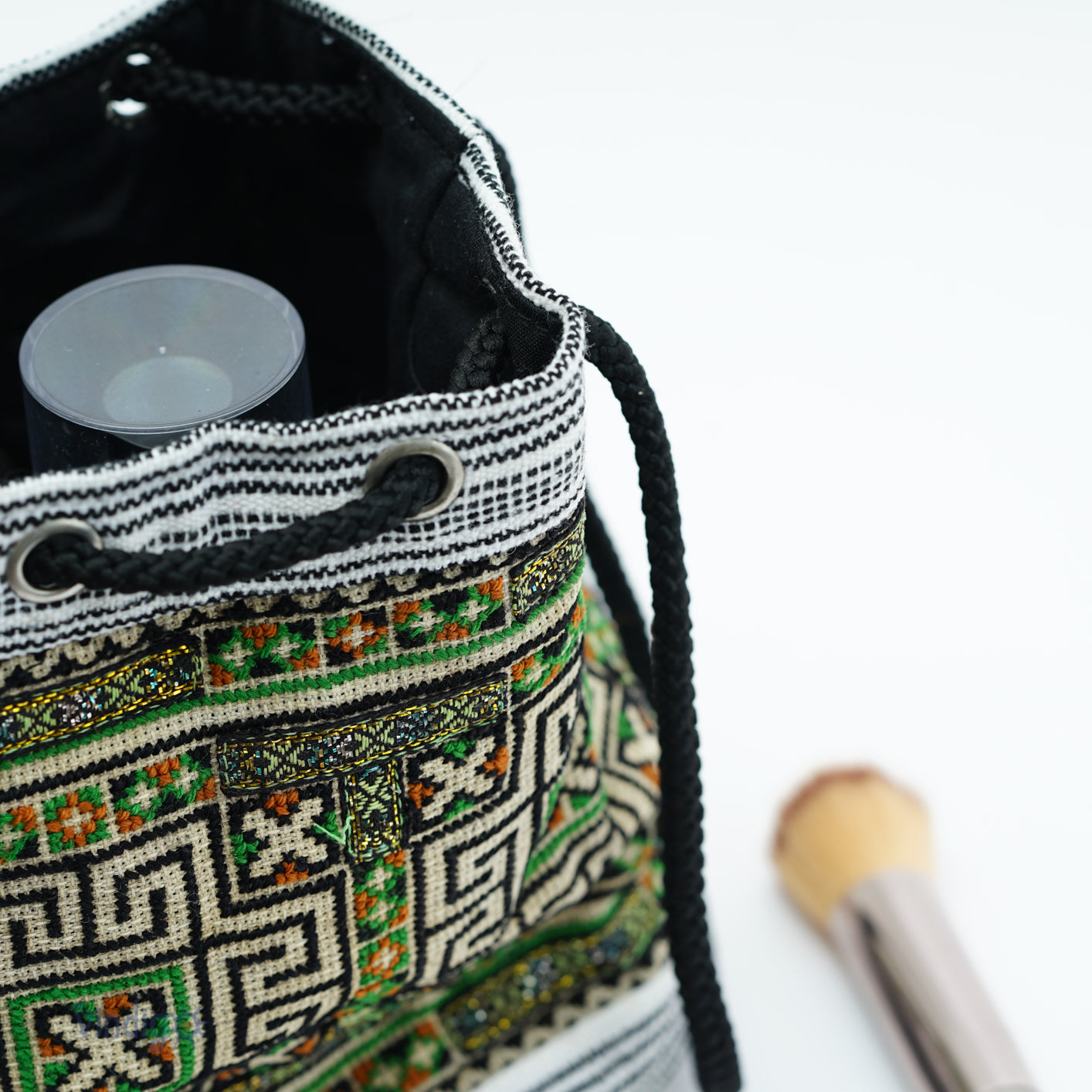 Mini hemp bag with string, tribal pattern in white on green background