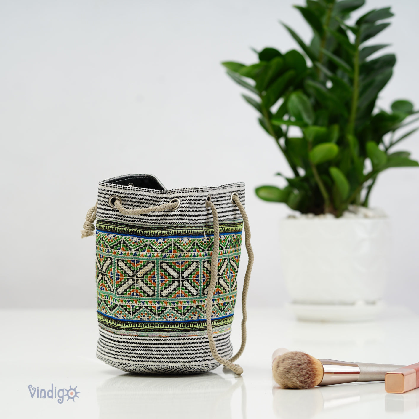 Beige mini hemp bag with string, black and white stripe with green tribal pattern